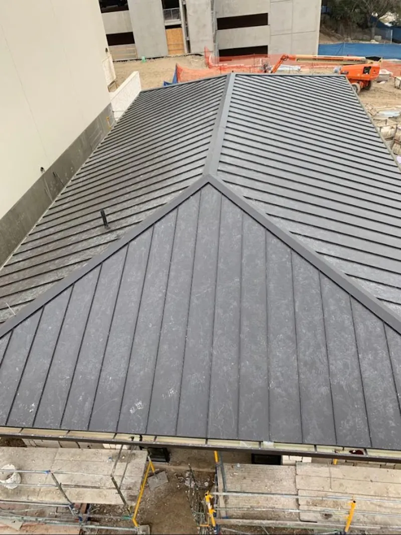 Commercial metal roof construction with crane equipment in Garwood